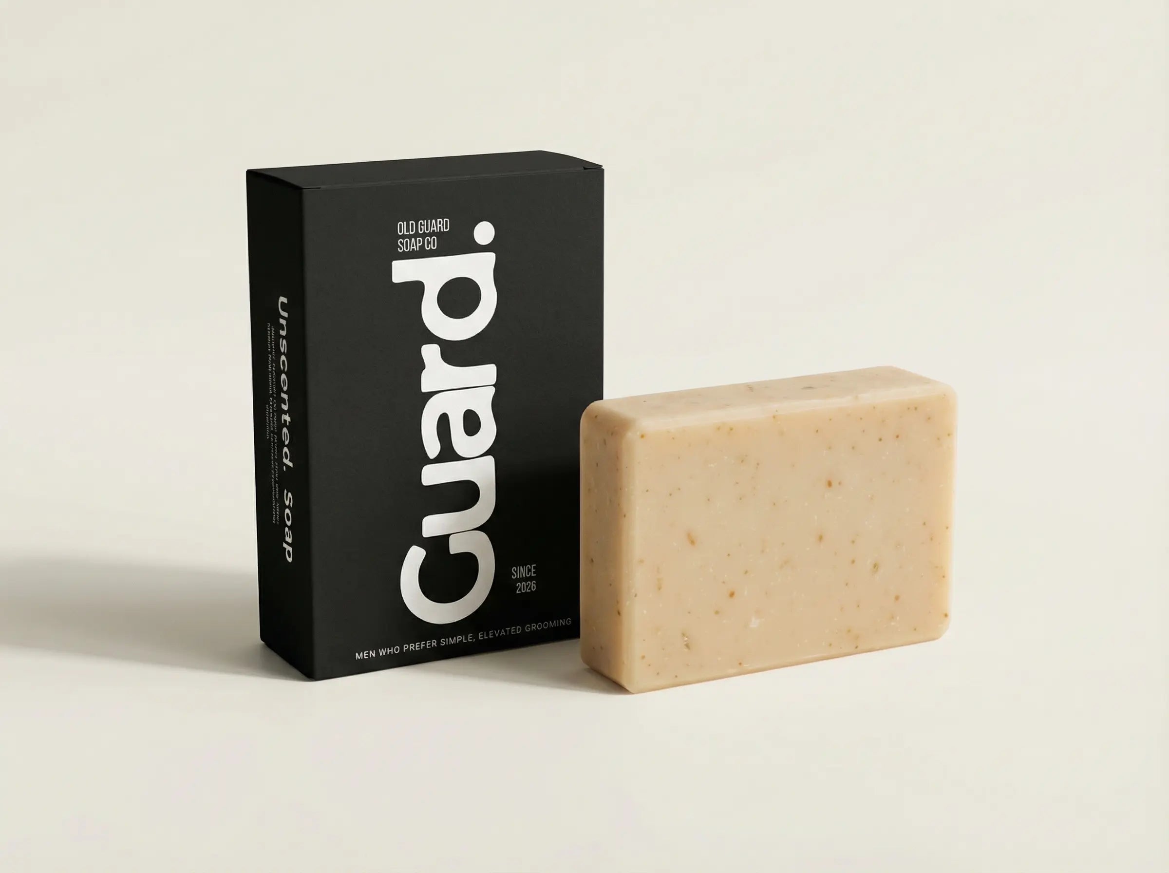 Bar of soap next to its black packaging with 'Guard!' branding on a light beige background