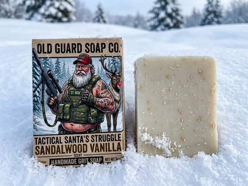 Bar of soap with Old Guard Soap Co. packaging in a snowy landscape