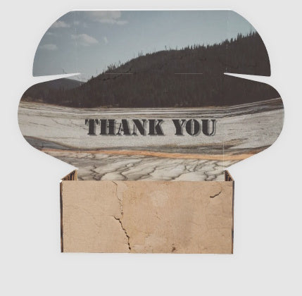 Supply box from Old Guard Soap Co with 'THANK YOU' text on a mountain landscape background