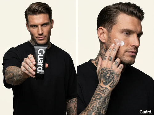 Man holding a 'Guard' skincare product and applying it to his face.
